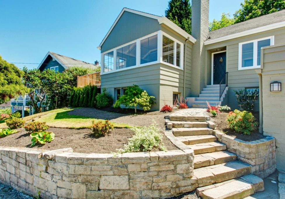 simple house with lots of natural stones for landscaping